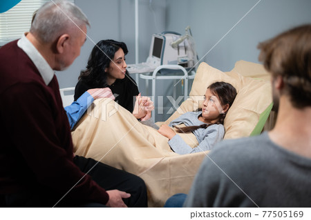 Healthcare concept - a family reunion in a hospital ward Healthcare concept - a family reunion in a hospital ward 77505169