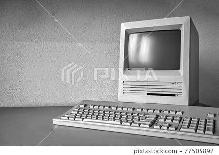 Old vintage monitor and computer on desk, retro workplace with copy space business, technology,internet concept 77505892