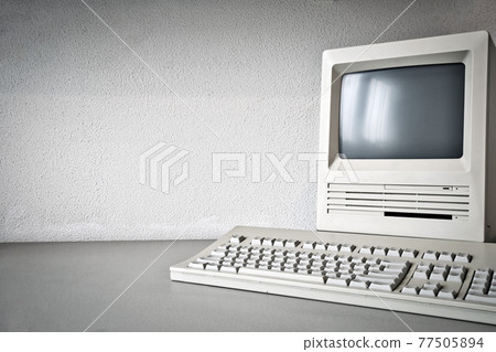 Old vintage monitor and computer on desk, retro workplace with copy space business, technology,internet concept 77505894