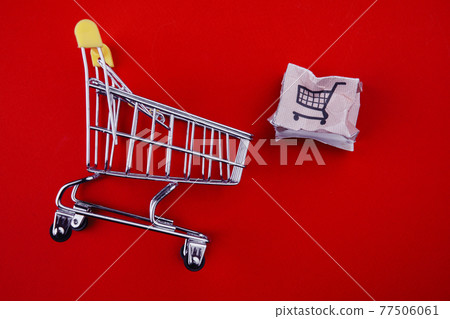 Shopping cart with spoiled box isolated on red. Delivery problem concept Shopping cart with spoiled box isolated on red. Delivery problem concept 77506061