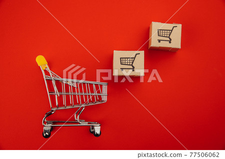 Shopping cart with boxes isolated on red Shopping cart with boxes isolated on red 77506062