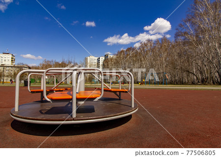 A new carousel on a new children's playground in an old residential area of the city. Improvement of the infrastructure of residential areas of the city. 77506805