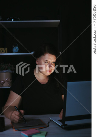 Designer drawing at graphic tablet late at night 77506856
