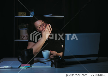 Tired sleepy woman yawning falling asleep at work Tired sleepy woman yawning falling asleep at work 77506862