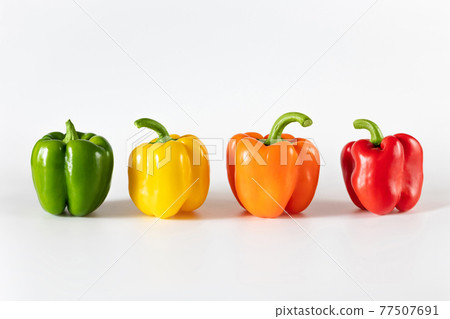 Colored bell peppers on white background. Green, yellow, orange and red pepper. Colored bell peppers on white background. Green, yellow, orange and red pepper. 77507691
