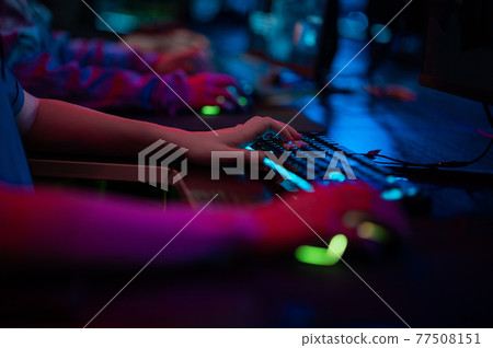 The hands of a male gamer during a tense game, the keyboard and mouse are visible. 77508151