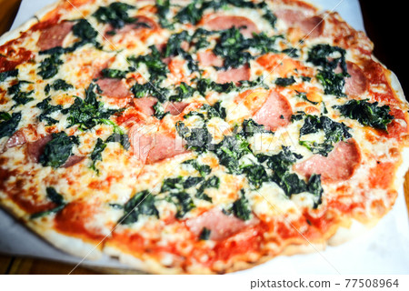 Homemade Pepperoni Pizza with tomatoes cheese and mushrooms on wooden table Homemade Pepperoni Pizza with tomatoes cheese and mushrooms on wooden table 77508964