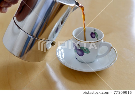 A relaxing moment with a cup of espresso A relaxing moment with a cup of espresso 77509916