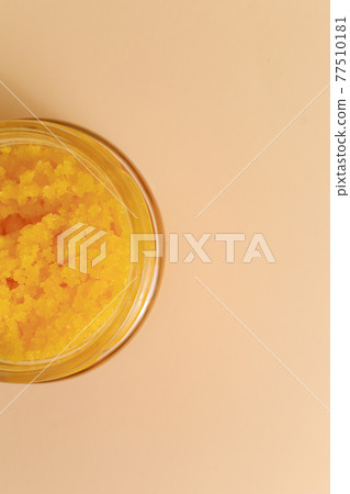 Body scrub of sea salt with lemon, rosemary and olive oil in glass jar on stone table, homemade cosmetic for Spa care 77510181
