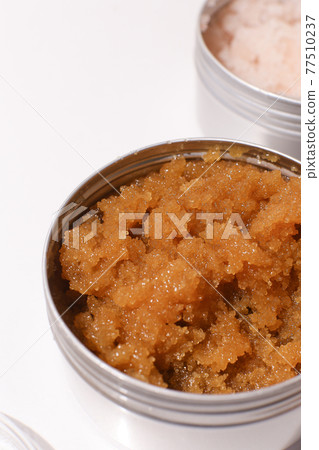 Body scrub of oatmeal, sugar, honey and oil in melat eco jar on white table, homemade cosmetic for peeling and spa care 77510237