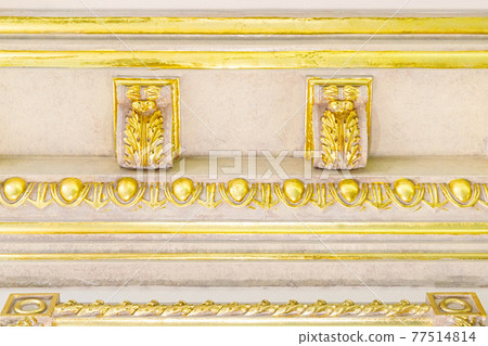 Close-up decorative gold stucco on the ceiling fillet in luxurious expensive interior of large baroque royal living room Close-up decorative gold stucco on the ceiling fillet in luxurious expensive interior of large baroque royal living room 77514814