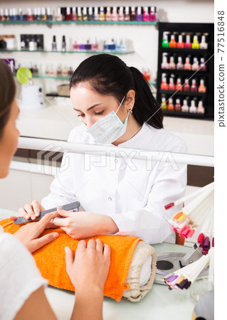 Manicurist shaping nails Manicurist shaping nails 77516848