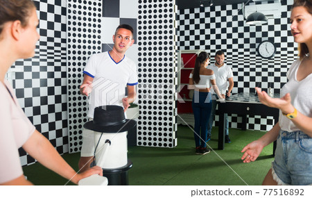 Adults are searching hints to get out of escape room Adults are searching hints to get out of escape room 77516892