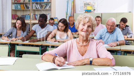 Mature woman take a written exam 77516976