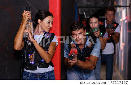 Group positive people playing laser tag game Group positive people playing laser tag game 77517167