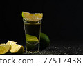 Gold Mexican Tequila shot with lime slice and salt. 77517438
