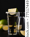Gold Mexican Tequila shot with lime slice and salt. 77517449