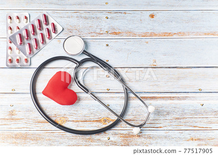 Stethoscope, pills and red heart. Heart check. Health concept Stethoscope, pills and red heart. Heart check. Health concept 77517905