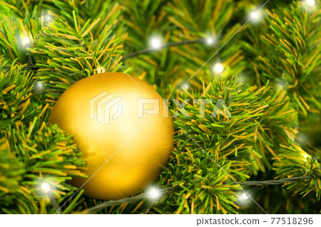 Christmas ball on tree. Closeup on Christmas tree decoration over festive background Christmas ball on tree. Closeup on Christmas tree decoration over festive background 77518296