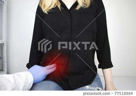 A woman suffers from pain in the appendix. Acute appendicitis, Crohn's disease, or inflammatory bowel disease. Surgeon examination and preparation for laparoscopic appendectomy 77518884