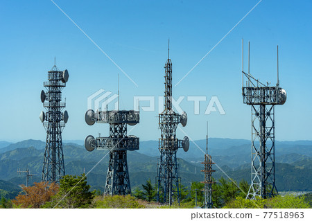 Large antenna group standing on the mountaintop 77518963