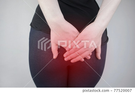 A woman holds his hands to the ass feeling pain. Conversion of pain in the rectum, hemorrhoids and pain in the excretory system of the body. Frequent bowel movements. 77520007