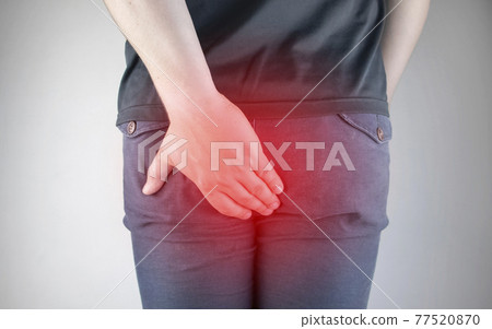 A man holds his hands to the ass feeling pain. Conversion of pain in the rectum, hemorrhoids and pain in the excretory system of the body. Frequent bowel movements. A man holds his hands to the ass feeling pain. Conversion of pain in the rectum, hemorrhoids and pain in the excretory system of the body. Frequent bowel movements. 77520870