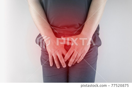 Man front view. Pain in the groin and bladder. The concept of pain in men as a result of prostatitis, inflammation of the bladder or genitourinary system. Frequent urination. 77520875