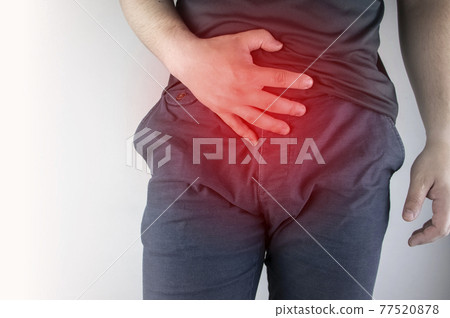 Man front view. Pain in the groin and bladder. The concept of pain in men as a result of prostatitis, inflammation of the bladder or genitourinary system. Frequent urination. 77520878
