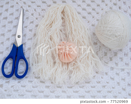 Scandinavian gnome with long beard red hat white knit background step by step handmade tutorial. Homemade DIY 77520969