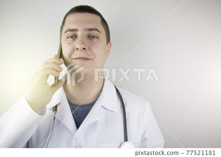 The doctor is talking on the phone with the patient. Remote assistance by phone. Modern medicine. The doctor answers questions on the mobile. 77521181