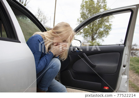 Nausea during a car trip. A blonde woman suffers from kinetosis. The concept of motion sickness in diseases of the transport and vestibular apparatus Nausea during a car trip. A blonde woman suffers from kinetosis. The concept of motion sickness in diseases of the transport and vestibular apparatus 77522214
