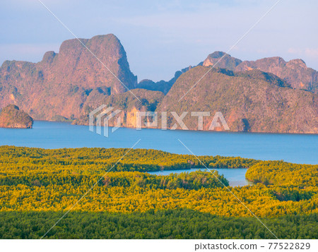 Rocky island beyond tropical jungle and bay (Phang Nga Province, Kingdom of Thailand) 77522829