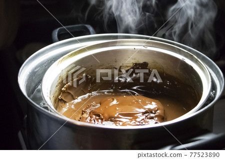 Melted chocolate in a pan under a water bath. Making hot chocolate at home in your own kitchen 77523890