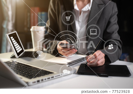 Business concepts, business people working in the work area with smartphones and data sheets at the desk. Business concepts, business people working in the work area with smartphones and data sheets at the desk. 77523928