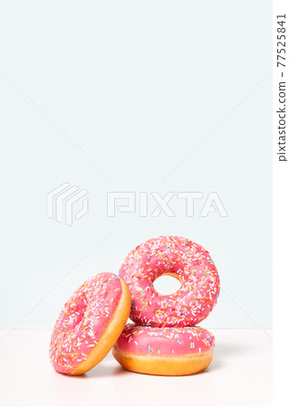 Fresh pink donuts in stack. Copy space. Fresh pink donuts in stack. Copy space. 77525841