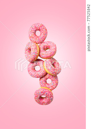 Cute pink donuts on pink background. Levitation. Cute pink donuts on pink background. Levitation. 77525842