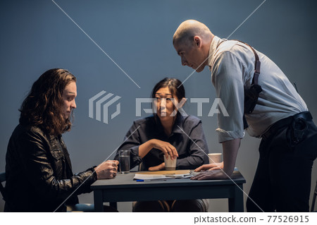 An experienced investigator and his assistant conduct an interview at the police station An experienced investigator and his assistant conduct an interview at the police station 77526915