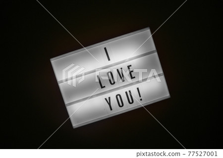 Lightbox with inscription I LOVE YOU glows in dark on black background Lightbox with inscription I LOVE YOU glows in dark on black background 77527001
