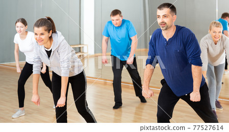 Woman training at group dance class Woman training at group dance class 77527614