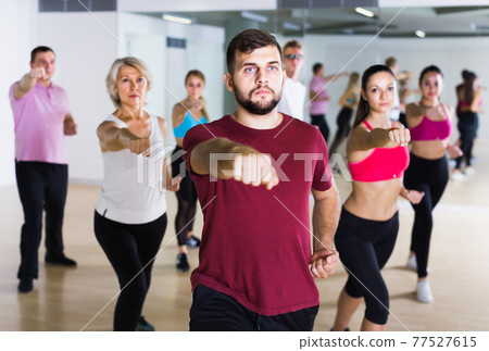 vigorous people posing in fitness studio vigorous people posing in fitness studio 77527615