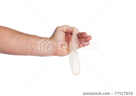 Hand holds a condom on a white background 77527858