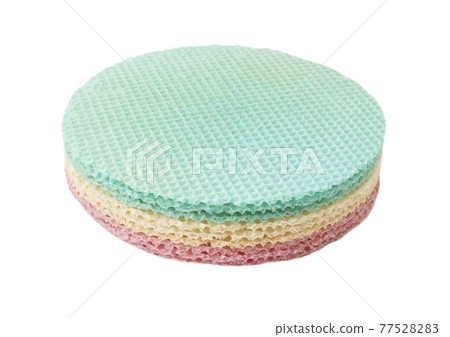 Multicolored waffle cake on a white plate, isolate. Close-up, sweet food 77528283
