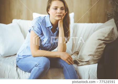 Tired upset woman worried about tiredness from domestic work and self isolation quarantine for COVID-19 Coronavirus. Mental health, anxiety depressed thinking young lady 77528591