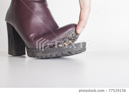 Poor-quality spring-autumn women s shoes in which the sole has come off. White background Poor-quality spring-autumn women s shoes in which the sole has come off. White background 77529136