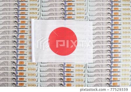 Japan flag on a background from dollar banknotes. Concept of the relationship of the Japanese money in relation to the dollar, the country's economy, financial 77529339