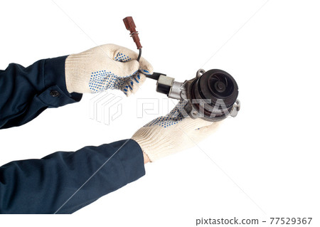 Car locksmith in uniform holds in his hand a car water pump on a white background, isolate. Car water pump wear and tear concept Car locksmith in uniform holds in his hand a car water pump on a white background, isolate. Car water pump wear and tear concept 77529367