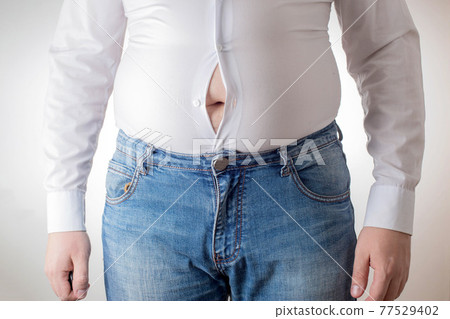 A fat man in a small, tight white shirt. Uncomfortable clothing concept, obesity. Slimming A fat man in a small, tight white shirt. Uncomfortable clothing concept, obesity. Slimming 77529402