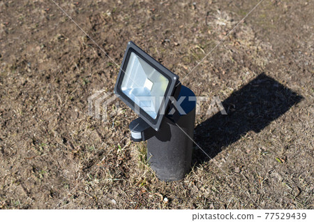 Outdoor diode floodlight with motion and light sensor, modern. Illuminated 77529439