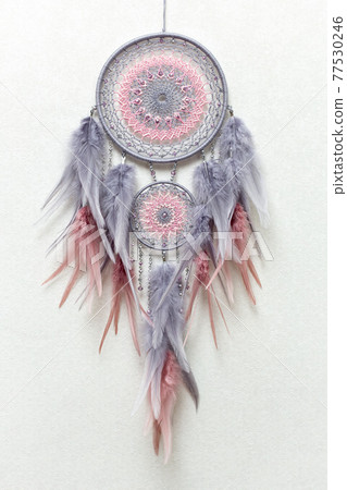 Handmade dream catcher with feathers threads and beads rope hanging on white background Handmade dream catcher with feathers threads and beads rope hanging on white background 77530246